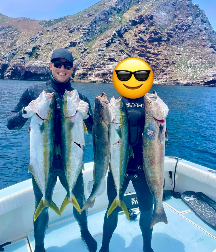 Two spearfishers on a boat at the Coronado Islands holding yellowtail and white seabass